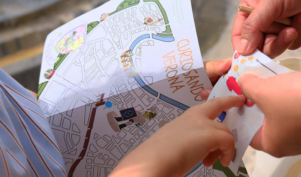 kid playing with map and stickers