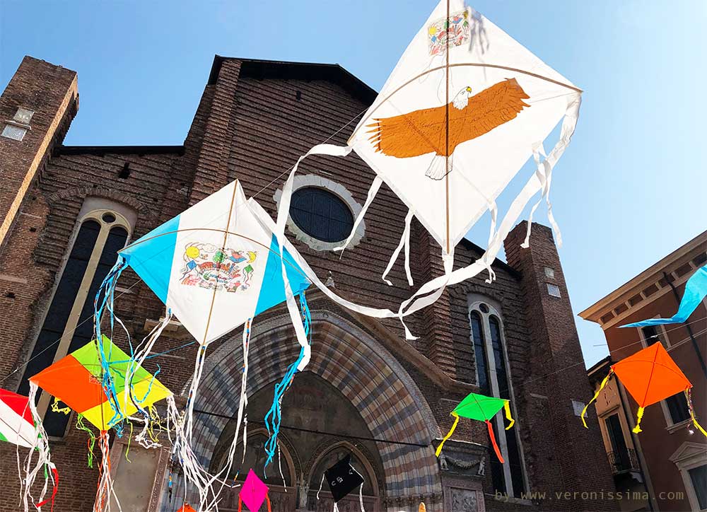 Kites flying in front of St. Anastasia church in Verona