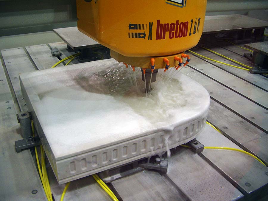 computer controlled drill machining a piece of marble