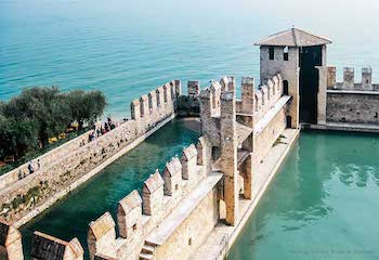 the dock of Sirmione's castle surrounded by walls and towers