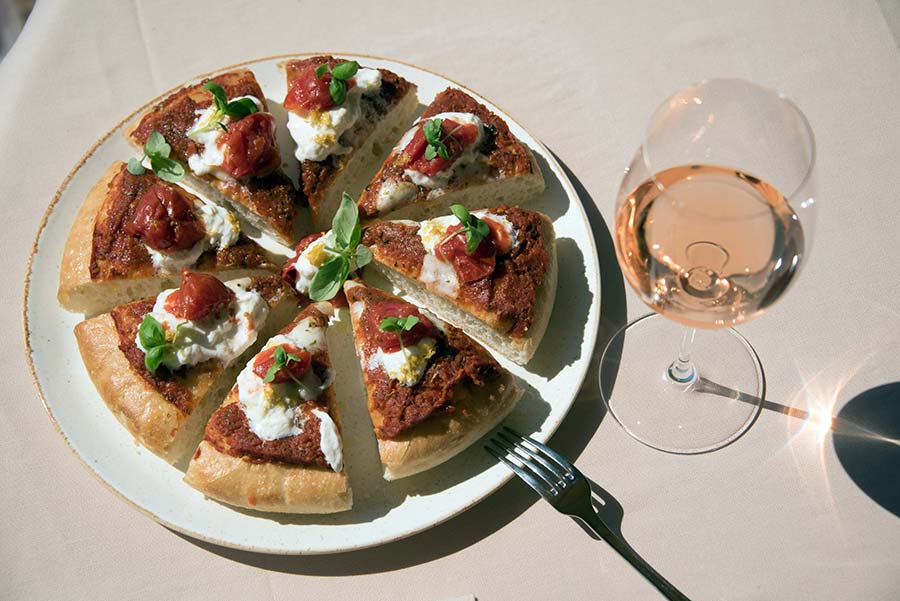 a glass of Bardolino rosÃ© wine paired with pizza
