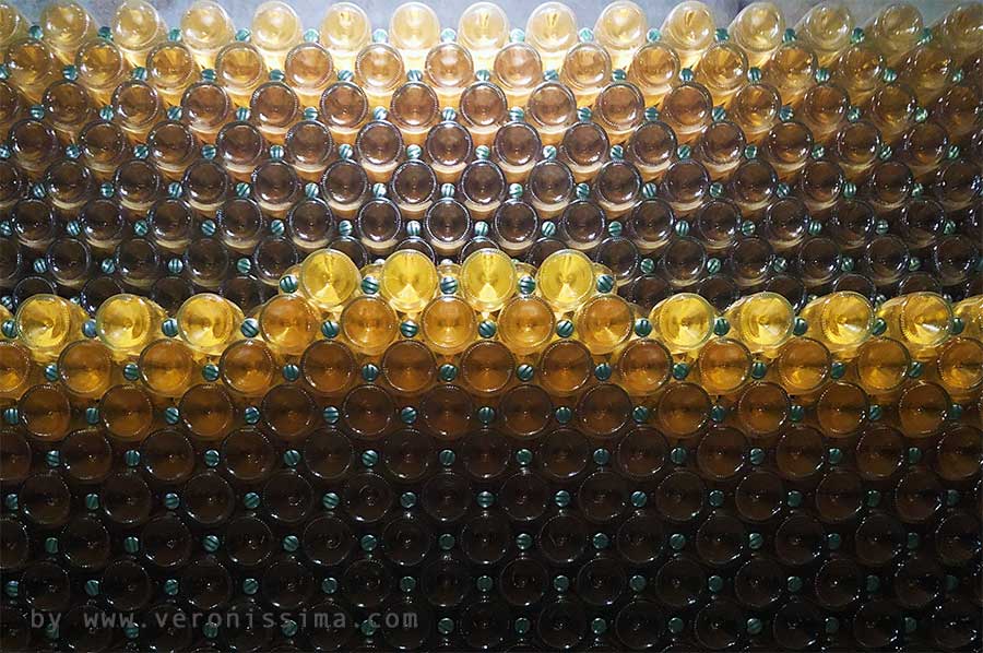 Stack of bottles in a winery that produce classic method sparkling wine