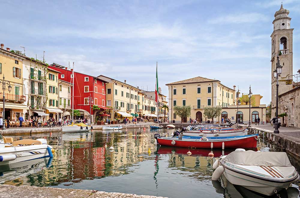 Overall view of Lazise with the dock, the boats and the church of St. Nicholas