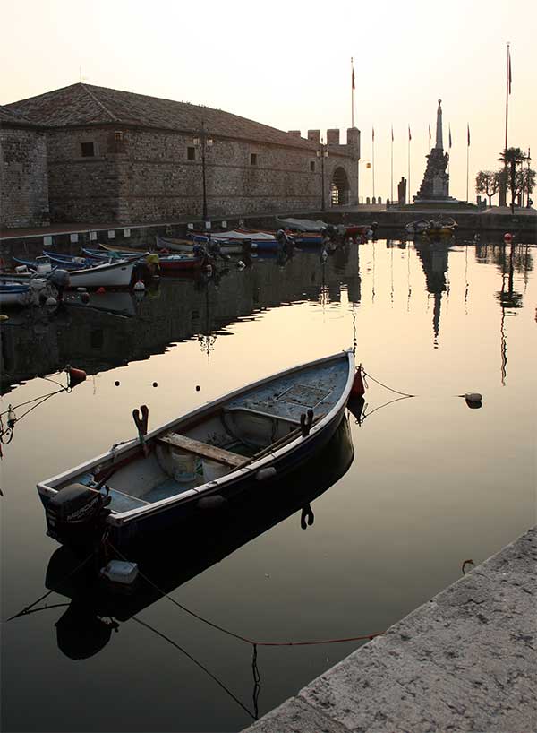 The dock of Lazise with the custom house from Venetian age