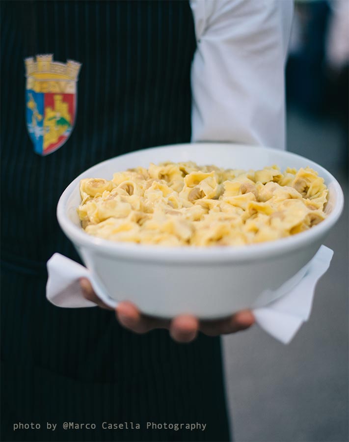 un cameriere porta una ciotola piena di tortellini di Valeggio