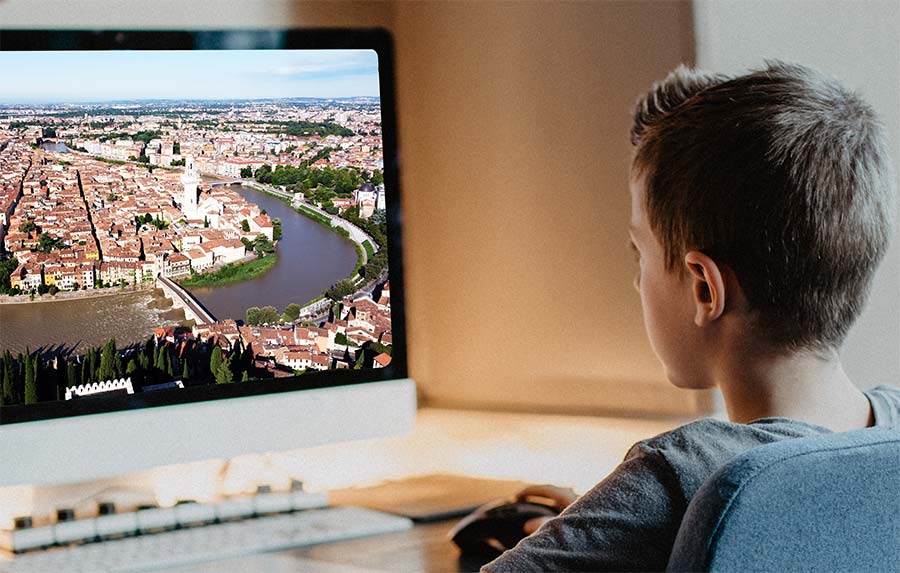 a young student participate a tour at his computer